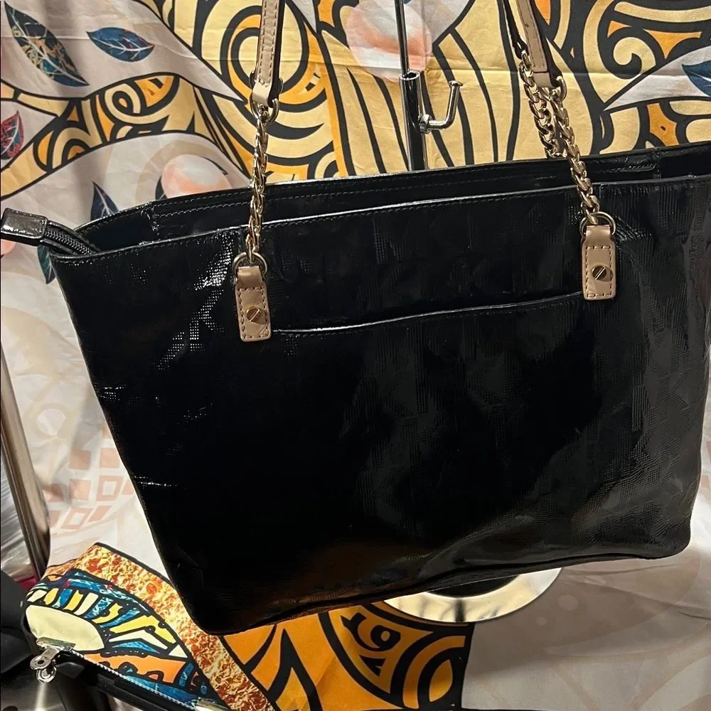 Michael Kors Jet Set Chain Tote in black patent leather with gold hardware.